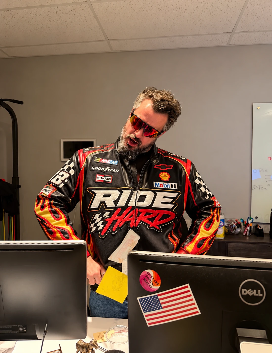 Ride Hard racing jacket and red sunglasses at the office